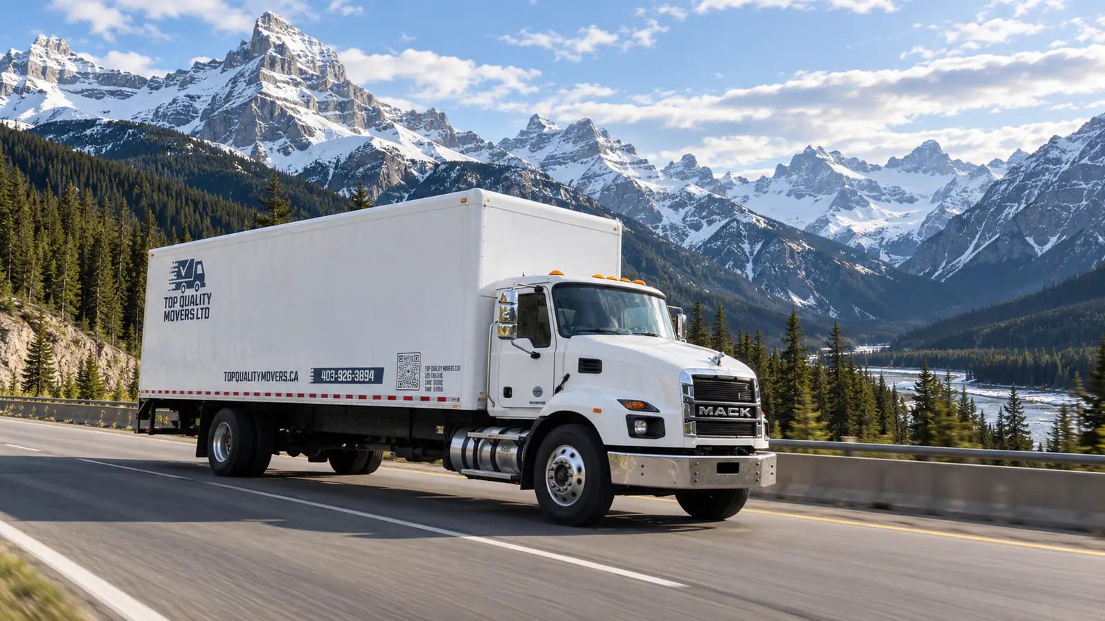 Calgary to Kelowna movers: a white moving truck on a highway through snow-capped mountains