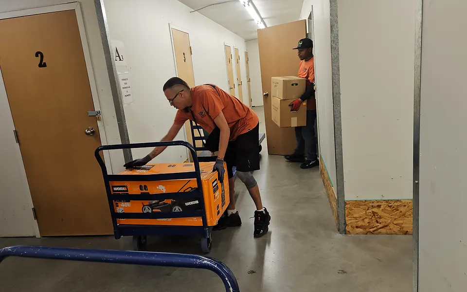 Our crew with a cart and boxes in a storage unit hallway in Montgomery, Calgary