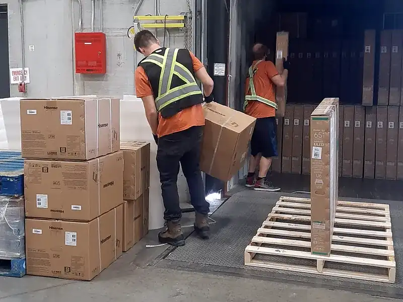 Our container unloading crew building a pallet at the dock door of a Calgary-area warehouse