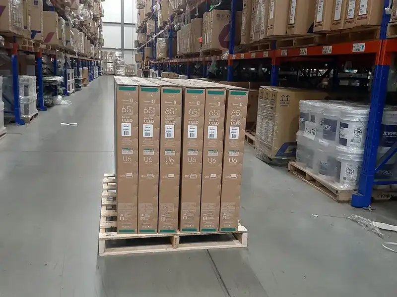 A pallet holding one carton size and model, sorted during container unloading at a Calgary-area warehouse