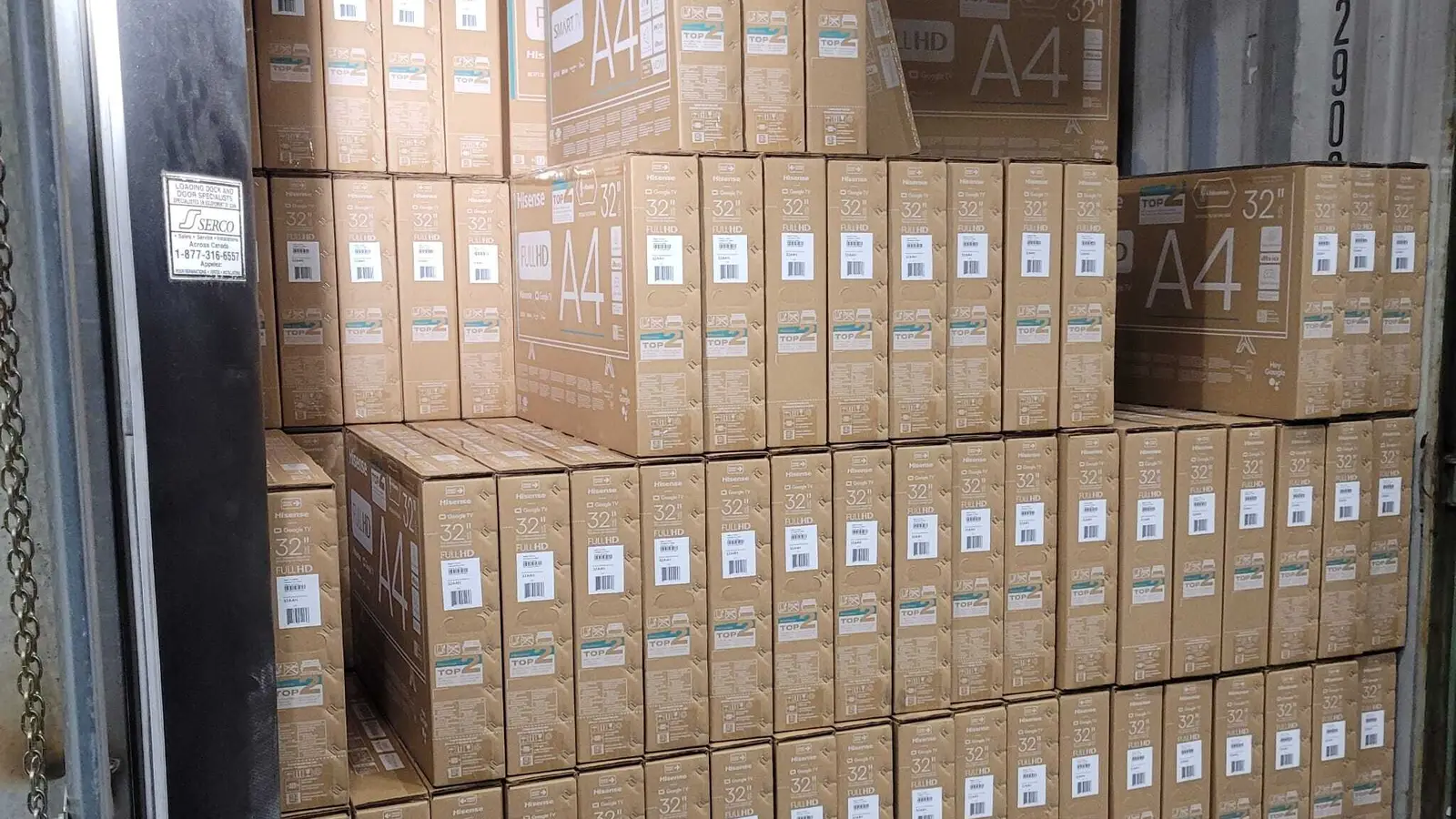 Container unloading in Calgary: an open shipping container stacked to the roof with floor-loaded cartons